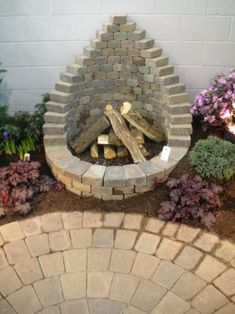 a fire pit made out of bricks in a garden