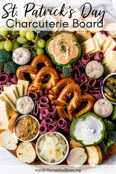 a platter filled with pretzels, cheeses and other snacks for st patrick's day