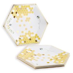 two yellow and white plates with honeycombs on them, one in the shape of a hexagon