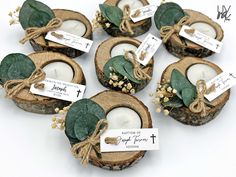 small candles are wrapped in twine and placed on wood slices with tags attached to them