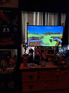 a flat screen tv sitting on top of a wooden dresser