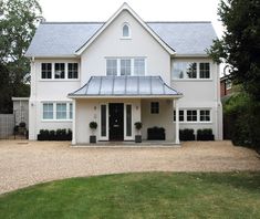 a large white house with a metal roof