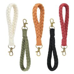 four different colored rope leashs with gold hooks on each side and two black, one white