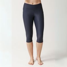 Cropped 3/4 length swim tights falling below the knee. Mid-waist. Discreet pocket to upper left thigh.  -UPF50+ sun protection  -Soft and breathable -Muscle control and shape retention -Two-way stretch for perfect fit  -Pilling resistant -Ultrachlorine resistant 78% ECONYL® regenerated nylon, 22% Elastane.   ECONYL® yarn is a 100% regenerated nylon fibre from pre and post-consumer waste such as fishing nets and other nylon waste. This sustainable techno-fabric is versatile, hyper-resistant, soft Yoga Activewear With Pockets Mid-thigh Length, Stretch Capris For Outdoor, Stretch Capri Length Capris For Outdoor, Sporty Stretch Capris For Outdoor Activities, Sports Capris With Pockets, Functional Sports Bottoms With Upf 50+, Functional Sport Bottoms With Upf 50+, Knee-length Sports Bottoms With Pockets, Stretch Activewear With Upf 50+ For Gym