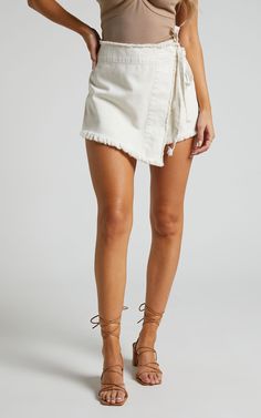 Ellyza Skort - Recycled Cotton Frayed Edge Wrap Denim Skort in Ecru | Showpo USA Cotton Jean Shorts With Frayed Hem For Day Out, Trendy Cream Cotton Shorts, Chic Cotton Shorts With Frayed Hem, Cotton Cutoff Bottoms For Day Out, Cotton Day Out Shorts, Beige Cotton Jean Shorts For Summer, Cotton Cutoff Shorts For Day Out, Cotton Shorts With Frayed Hem For Day Out, Cream Denim Bottoms For Summer