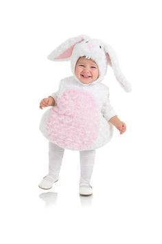 a baby in a bunny costume is smiling at the camera while standing on one leg