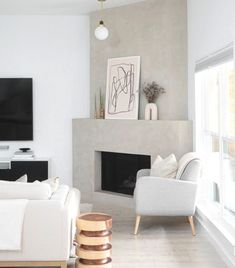 a living room filled with furniture and a flat screen tv mounted on the wall above a fire place