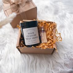 an open gift box containing matches, candles and a candle in it on a white furnishing