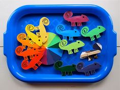 a blue tray filled with cut out animals