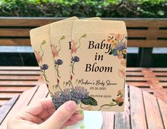 the baby in bloom book is being held up