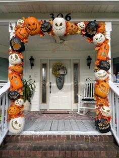 the front porch decorated for halloween with pumpkins and jack o lanterns