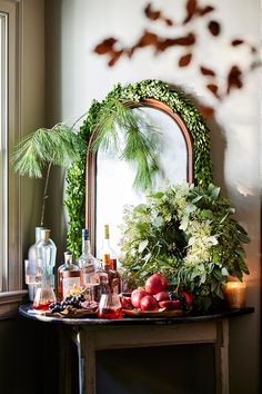 a mirror sitting on top of a table filled with fruit and vegtables