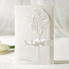 a white card with a flower on it