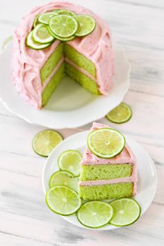 there is a cake with limes on the top and one slice cut from it