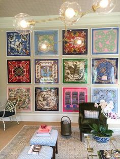 a living room filled with lots of colorful pictures on the wall above a coffee table