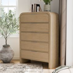 a wooden dresser sitting next to a window in a room with a rug on the floor