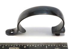 an iron handle is shown next to a ruler