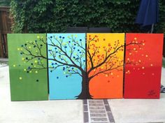 four painted canvass with a tree on them