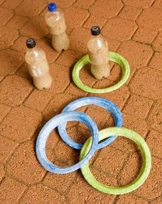 the olympic rings are on the ground next to two empty water bottles and one empty plastic bottle