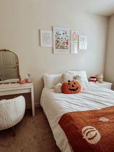 a bedroom with a bed, mirror and pictures on the wall