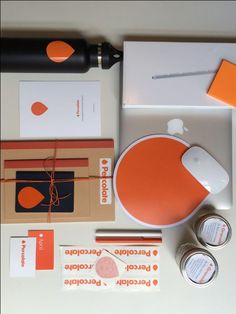 the contents of an orange and white stationery set