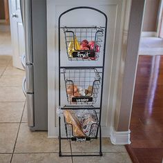 a metal rack with three baskets on top of it