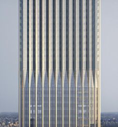 a very tall building with many windows on it's side in front of the city