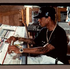 a man sitting in front of a mixing desk