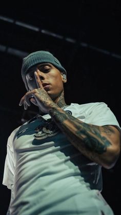 a man with tattoos on his arms and hands