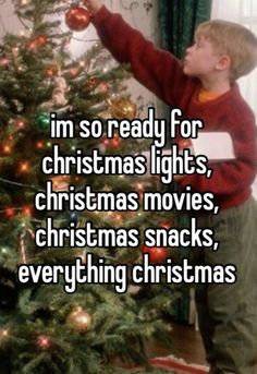 a young boy decorating a christmas tree with the words i'm so ready for christmas