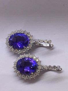 For Sale on 1stDibs - Natural Oval Tanzanite and Diamonds Earrings is set in 14K white Gold. Total weight of Tanzanite is 16.90 Carat and Total Diamond is 1.18 Carat. The earring Luxury Tanzanite White Gold Earrings, Luxury White Gold Tanzanite Earrings, Formal Round Diamond Earrings With Gemstones, White Gold Tanzanite Gemstone Earrings, Formal Tanzanite Earrings In Fine Jewelry Style, Formal Tanzanite Gemstone Earrings, Exquisite Formal Earrings With Halo Setting, Exquisite Halo Setting Earrings For Formal Occasions, Tanzanite Gemstone Earrings For Formal Occasions