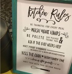 a kitchen rules sign hanging on the wall