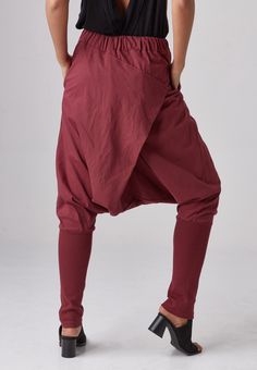 "🚚..ALL ORDERS ARE SHIPPED VIA DHL EXPRESS MAIL Relaxed fit dropped-crotch pants in red. Asymmetric crossover fabric panel at front and back with 3 buttons front detailed. Elastic waistband and two hand pockets at side seam. Roll up the cuffed hem for an utlra relaxed look! * Pull-on style * Drop-crotch style * 2\" Elastic waistband * Side seam pockets * Wide cuffed hem Measurements approximately: Waist : 26\" (66 cm) stretching to 48\" (122 cm)-elastic material Hips : 50\" (122 cm) Outseam: 38 Red Baggy Trousers, Red Cotton Harem Pants For Fall, Baggy Red Harem Pants With Pockets, Red Baggy Harem Pants With Pockets, Red Baggy Long Pants, Red Baggy Cotton Pants, Red Baggy Cotton Bottoms, Red Harem Pants With Pockets And Relaxed Fit, Red Relaxed Fit Harem Pants With Pockets