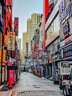 an empty city street lined with tall buildings