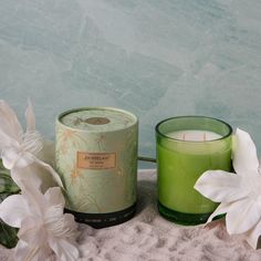 two candles sitting next to each other on a table