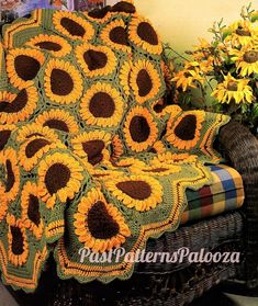 a crocheted blanket with sunflowers on it