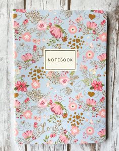 a blue notebook with pink flowers on it