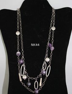 Round amethyst beads, silver coin beads, cylinder, and textured ovals combine with silver chain to form a delicate necklace that will be a highlighted addition to any outfit.  Sure to draw compliments, this necklace will lighten up a dark winter outfit like nothing else.  Would look great against a dark turtleneck sweater this season.  From a design by Annie's Attic.  NK44 Elegant Metal Necklaces With Gemstone Beads, Purple Jewelry With Natural Stones In Metal, Purple Metal Jewelry With Natural Stones, Purple Jewelry With Natural Stones, Double Strand Amethyst Gemstone Beads Jewelry, Amethyst Double Strand For Jewelry Making, Purple Double Strand Jewelry With Natural Stones, Double Strand Purple Jewelry With Natural Stones, Purple Double Strand Natural Stones Jewelry