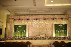 an empty banquet hall with floral decorations and chandeliers