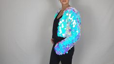 Add a whole lot of SPARKLE to your outfit with an adorable sequin jacket! This listing is for a waist or cropped length sequin jacket with white satin lining, made to order in your size. This piece differs from my sequin kimonos in its shape and sleeve style - the jacket is more fitted with a long sleeve, while the kimono has a more body shape with shorter, wider sleeves.  I can make this piece in a variety of colors (dependent on fabric availability!) In the listing photos I have some examples of colors available in the larger teardrop shape, and I currently have iridescent, silver, pink, and gold sequin fabric in stock in the smaller circle sequins. Send me a message if you are interested in customization! I would be happy to change the length, change the lining, add pockets or a hood, a White Sequined Outerwear For Party, Spring Sequin Outerwear For Costume Party, Iridescent Sequin Fabric For Spring, Black Mesh Fabric, Gold Sequin Fabric, Sequin Kimono, Gender Nonconforming, Bolero Shrug, Mermaid Sequin