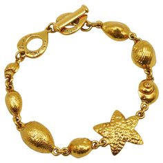 YVES SAINT LAURENT vintage link bracelet featuring a sealife design. Gold tone metal hardware. Spring/Summer 1994 Collection. T bar closure. Love heart clasp. Embossed YVES SAINT LAURENT on the love hearts. Indicative measurements : adjustable length from approx. 21 cm (8.27 inches) to approx. 23 cm (9.06 inches) / max. width approx. 2.1 cm (0.83 inch). NOTES - This is a preloved vintage item, therefore it might have imperfections. - Colors may differ slightly from actual product appearance due Yves Saint Laurent Vintage Jewelry, Yves Laurent, Ysl Jewelry, Ysl Vintage, Saint Laurent Vintage, Vintage Ysl, Vintage Spring, Vintage Jewels, Jewelry Inspo