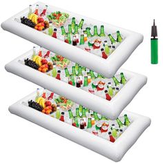 two inflatable trays filled with drinks and fruit