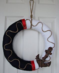 a wreath with an anchor hanging on the front door