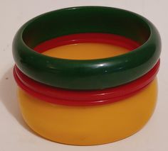 Gorgeous set of 4 bakelite bracelets one green and one yellow with2 redspacers. Excellent used condition tested and authentic. Please see all photos. Approx 1/4" to1" 2.5" opening  As The owners of beyond bakelite want you to have the best experience. All items are used and handpicked and thoroughly described with any flaws or condition issues. All items are shipped within 1 to 3 business days and insured. We do reuse boxes and some supplies to keep costs down and it's great for the environment. Reuse Boxes, Bakelite Bracelets, Bakelite Bangles, Red Green Yellow, Bangle Set, Green Yellow, Bangle Bracelets, Happy Shopping, Vintage Items