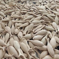 a pile of wooden spoons sitting on top of a table next to each other