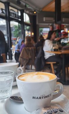 a cappuccino is sitting on a saucer