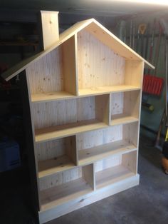 a wooden shelf with shelves built into the top and bottom, sitting in a garage