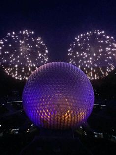 fireworks are lit up in the night sky over spaceship land