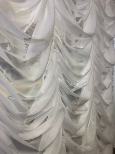 the curtain is covered with white fabric and it looks like they have been folded up