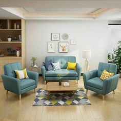 a living room filled with blue couches and chairs next to a wooden coffee table